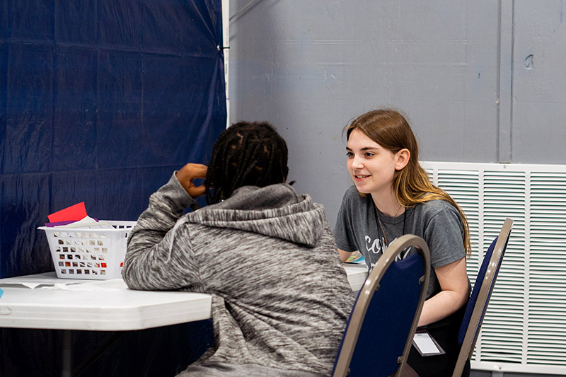 volunteer-smiling-at-child