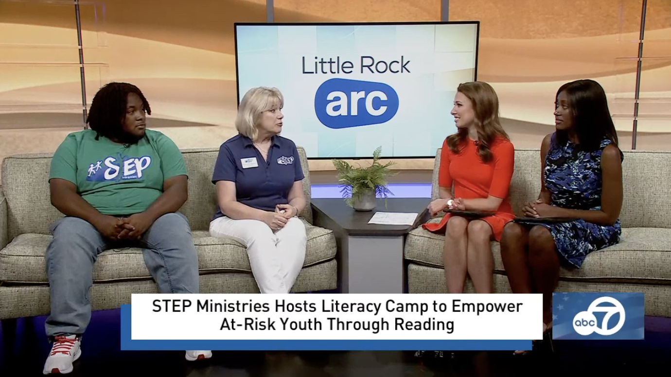 unnamed (3) Four people sit on two couches during a TV interview. The screen behind them displays Little Rock arc. A banner reads, STEP Ministries Hosts Literacy Camp to Empower At-Risk Youth Through Reading. The ABC 7 logo is visible.